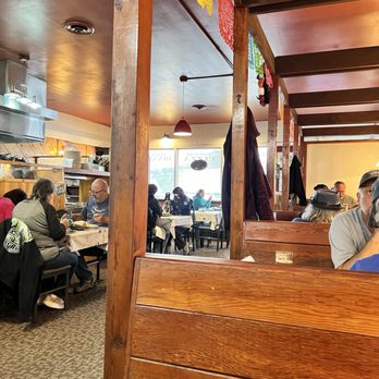 D'Aurelios - Seating area. 6 wooden booths along one wall and tables with chairs in the rest of the dining room - Pizza Near Me - Fort Bragg, California
