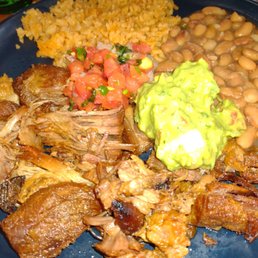 a plate of food with beans, rice, meat, and guacamole a plate of food with beans, rice, meat, and guacamole