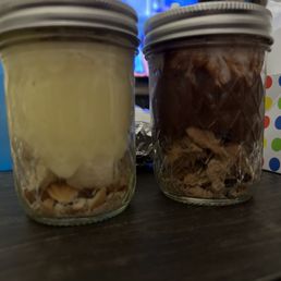 two jars of dessert in front of a television two jars of dessert in front of a television