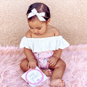 Tea For Three: A Children's Boutique - White off-shoulder onesie, pink floral bummies and white velvet head bow. - Children's Clothing Near Me - Yuma, Arizona Tea For Three: A Children's Boutique - White off-shoulder onesie, pink floral bummies and white velvet head bow. - Children's Clothing Near Me - Yuma, Arizona
