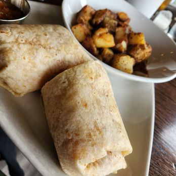 Carnivore - Breakfast burrito with a side of potatoes - Steakhouses Near Me - St. Louis, Missouri
