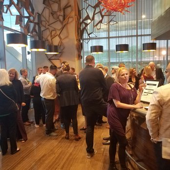 Ritz Bar - a large group of people standing around a bar - International Near Me - Toronto, Ontario Ritz Bar - a large group of people standing around a bar - International Near Me - Toronto, Ontario