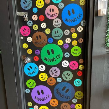 Moodz - a bunch of smiley faces on a door - Vegan Near Me - Pittsburgh, Pennsylvania