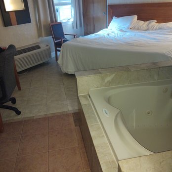 Great Cedar Hotel - Size of "luxury" room.  King bed, whirlpool, table, one side table and dehumidifier.  All tile. Be careful not to skip water splashes out. - Hotels Near Me - Mashantucket, Connecticut