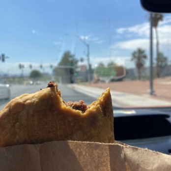 Yaad Patty - a person holding a piece of food in their hand - Caribbean Near Me - North Las Vegas, Nevada Yaad Patty - a person holding a piece of food in their hand - Caribbean Near Me - North Las Vegas, Nevada
