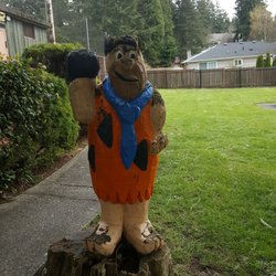 Fircrest Tot-Lot - A Fred Flintstone wooden display at the Tot Lot.