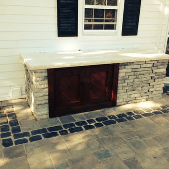 Arrowhead Brick Pavers - Jim created this enclosure around our window well and electric meter.  He capped it with an actual piece of limestone. - General Contractors Near Me - Bristol, Illinois