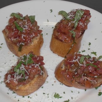 Bona Roma Pizza - four pieces of bread topped with tomato sauce and parmesan cheese - Pizza Near Me - Calgary, Alberta Bona Roma Pizza - four pieces of bread topped with tomato sauce and parmesan cheese - Pizza Near Me - Calgary, Alberta