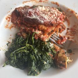 Eggplant Parmesan with sautéed spinach on the side