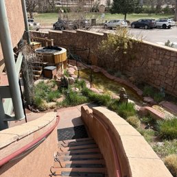 Stairs down to the bottom level where the sauna, cold plunge, and saline pools are located. Stairs down to the bottom level where the sauna, cold plunge, and saline pools are located.