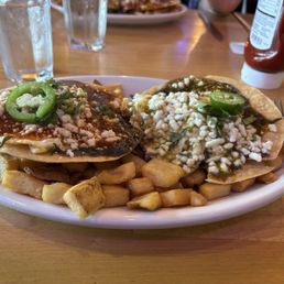 Divorced eggs over medium with yummy red and green sauce. Over your typical fried potatoes.