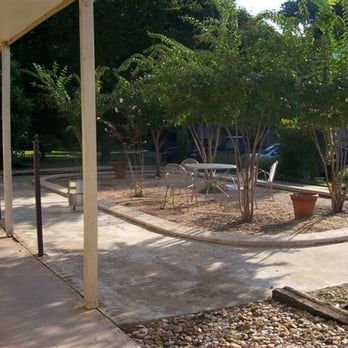 Antilles Apartments - The courtyard, previously a pool that was filled in with dirt due to filth. - Apartments Near Me - Austin, Texas