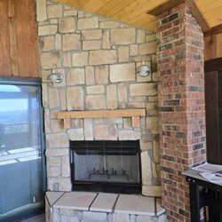 Lakeside Chimney - Covered deck we built a hearth in the corner, installed a wood burning fireplace, stone veneer, wood mantle, electrical outlet & lamps. done