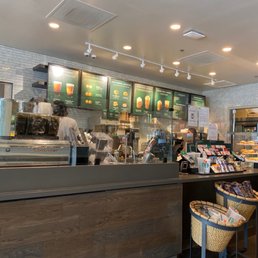 a coffee shop with a counter with a variety of items a coffee shop with a counter with a variety of items