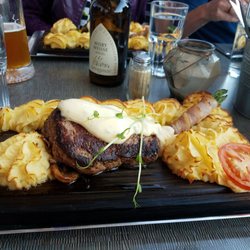 Torgkrogen - Husets Plankstek - Fillet of beef served on a wooden plank topped with a bearnaise sauce with mashed potatoes and bacon wrapped asparagus.