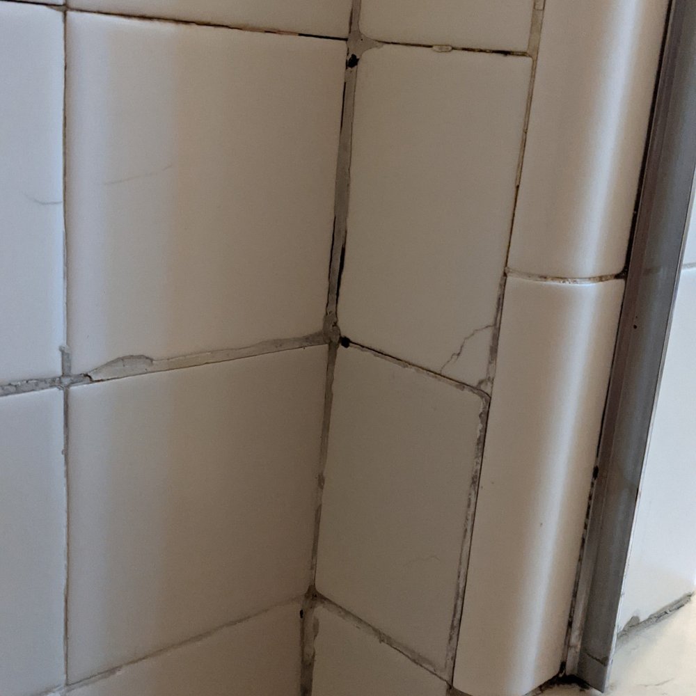 The Tile Solution - Shower: Before photo 2: Our bathroom from 1935 had ugly repairs, cracks and missing grout. - Flooring Near Me - Mount Kisco, New York The Tile Solution - Shower: Before photo 2: Our bathroom from 1935 had ugly repairs, cracks and missing grout. - Flooring Near Me - Mount Kisco, New York