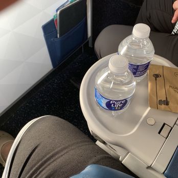 TGI Fridays DFW Terminal E17 - Water in first class with ear buds. - American Near Me - Dallas, Texas TGI Fridays DFW Terminal E17 - Water in first class with ear buds. - American Near Me - Dallas, Texas