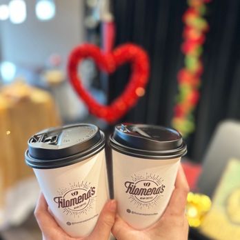 Filomena's Bean Coffee - a hand holding two coffee cups - Coffee & Tea Near Me - Davie, Florida