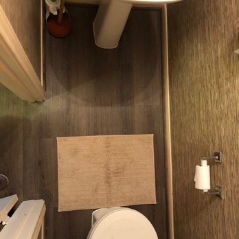 US Remodeling & Floors - a bathroom with a toilet and sink - General Contractors Near Me - Cypress, Texas US Remodeling & Floors - a bathroom with a toilet and sink - General Contractors Near Me - Cypress, Texas