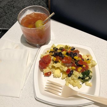 Delta Sky Club - Eggs with Spinach, Roasted Tomatoes, Salsa, Black Beans, and Corn.  Spicy Bloody Mary. - Airport Lounges Near Me - Dallas, Texas