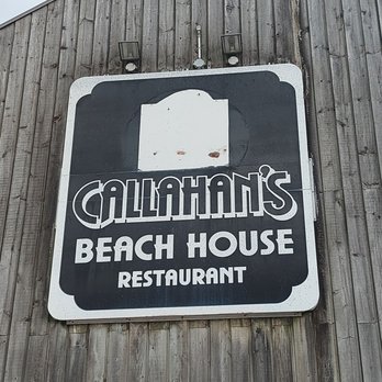 The Beach House - a sign on the side of a building - Fish & Chips Near Me - Port Dover, Ontario