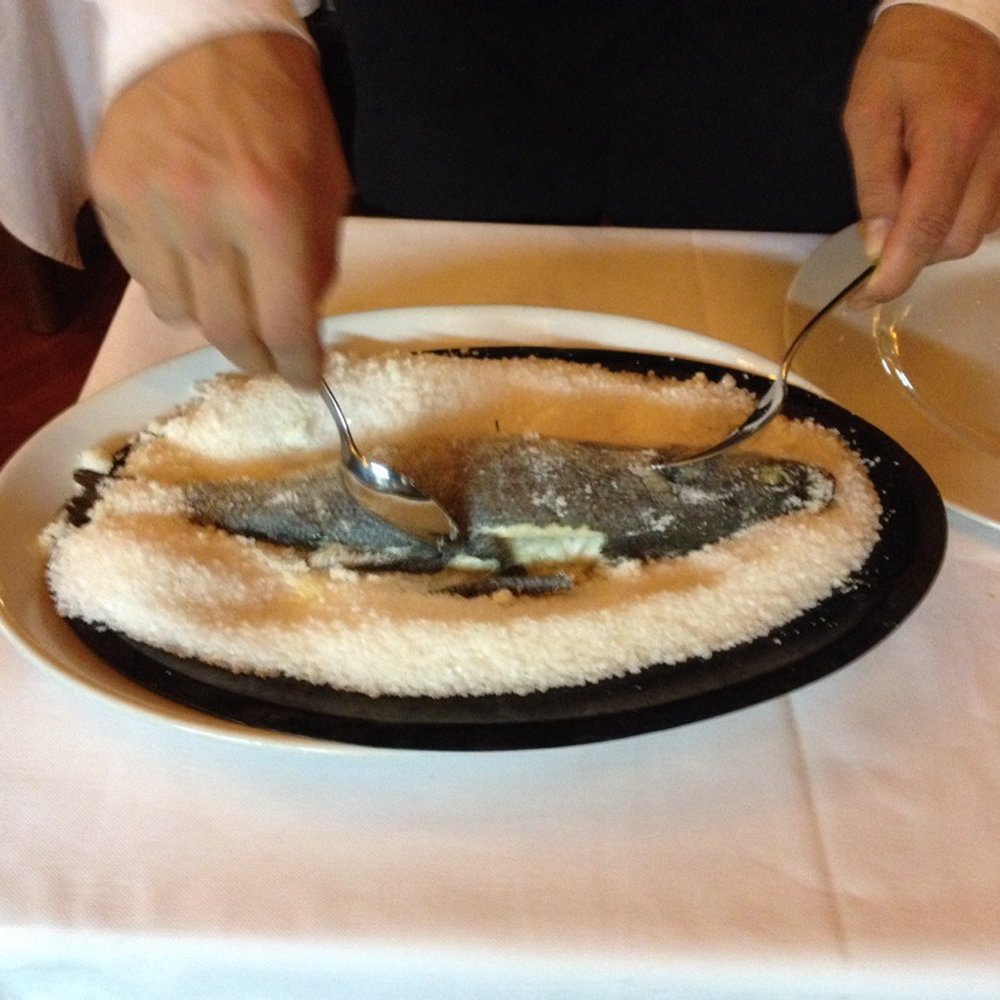 Limone - Seabass  being filleted at my table by waiter. Delicious and lite. - Pizza Near Me - Milan, Michigan