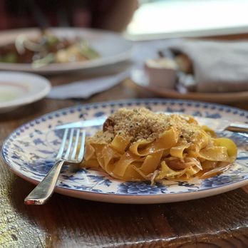 Oakleaf - a plate of pasta on a wooden table - New American Near Me - Carrboro, North Carolina