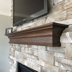 Custom Corners - Traditional fireplace mantel with light distressing in a warm brown with black glaze.