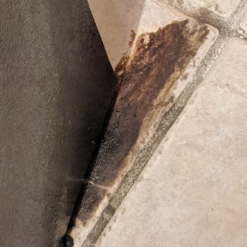 Stanley Steemer - A typical buildup of food drips and spills under front of frig - Carpet Cleaning Near Me - Clifton, New Jersey