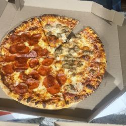 Domino's Pizza - They cut a 1/16th SLICE out of TWO of mu pizzas then gave it to me...never go here absolutely horrible service ontop of that