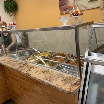 El Sol Del Caribe - a woman preparing food in a deli - Dominican Near Me - Jersey City, New Jersey El Sol Del Caribe - a woman preparing food in a deli - Dominican Near Me - Jersey City, New Jersey