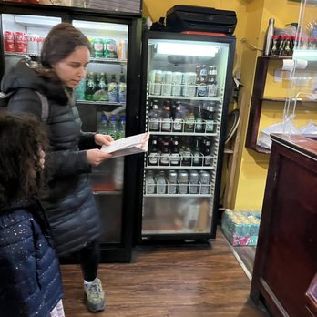 Injapan - a woman and a child in a store - Sushi Bars Near Me - Toronto, Ontario
