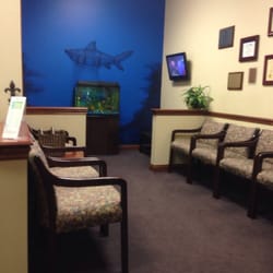 Avon Dental Centre - Waiting & kids area w/ aquarium and cartoons.