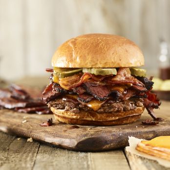 Smashburger - bacon, pickles, and cheese on a wooden cutting board - Burgers Near Me - Oak Brook, Illinois Smashburger - bacon, pickles, and cheese on a wooden cutting board - Burgers Near Me - Oak Brook, Illinois