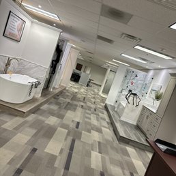 a bathroom with a large tub in the middle of the room