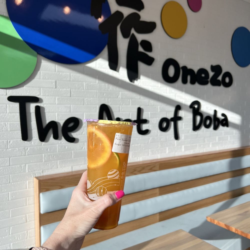 Onezo - a hand holding a cup of orange juice - Bubble Tea Near Me - Tampa, Florida Onezo - a hand holding a cup of orange juice - Bubble Tea Near Me - Tampa, Florida