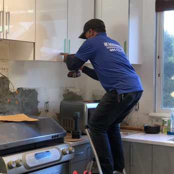 Arc Bath & Kitchen Solution - a man on a ladder in a kitchen - General Contractors Near Me - Surrey, British Columbia Arc Bath & Kitchen Solution - a man on a ladder in a kitchen - General Contractors Near Me - Surrey, British Columbia