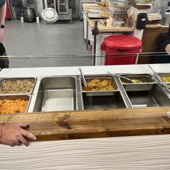 Casera Latin Kitchen and Bakery - Hot food case being set up - Peruvian Near Me - Oceanside, California