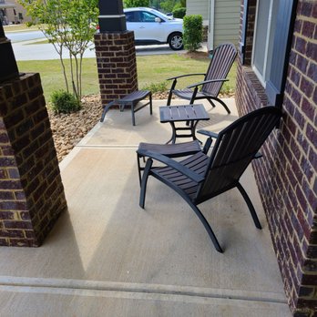 The Surface Pros - a row of lawn chairs on a porch - Painters Near Me