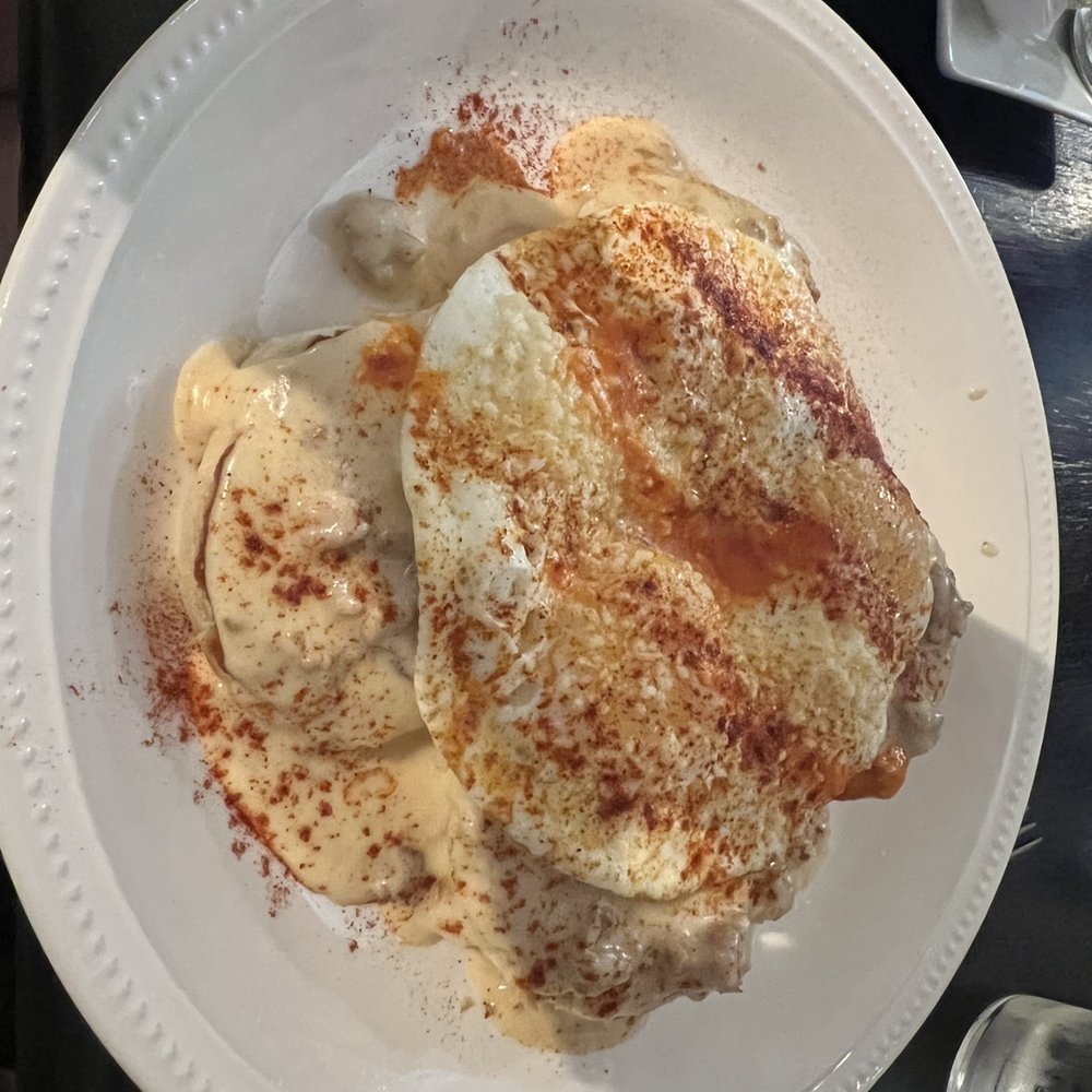 Author's Kitchen + Bar - Buscuit and Gravy with egg on top. Taste as good as it looks.  For my palette one of the best.  I'll be back for this one again - Bars Near Me - Appleton, Wisconsin