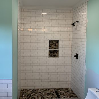 Wesly Construction - a bathroom with a tiled shower - General Contractors Near Me