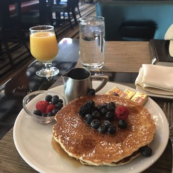 Eric's Restaurant - Short stack (3) of pancakes with seasonal fruit and maple syrup - American Near Me - Houston, Texas
