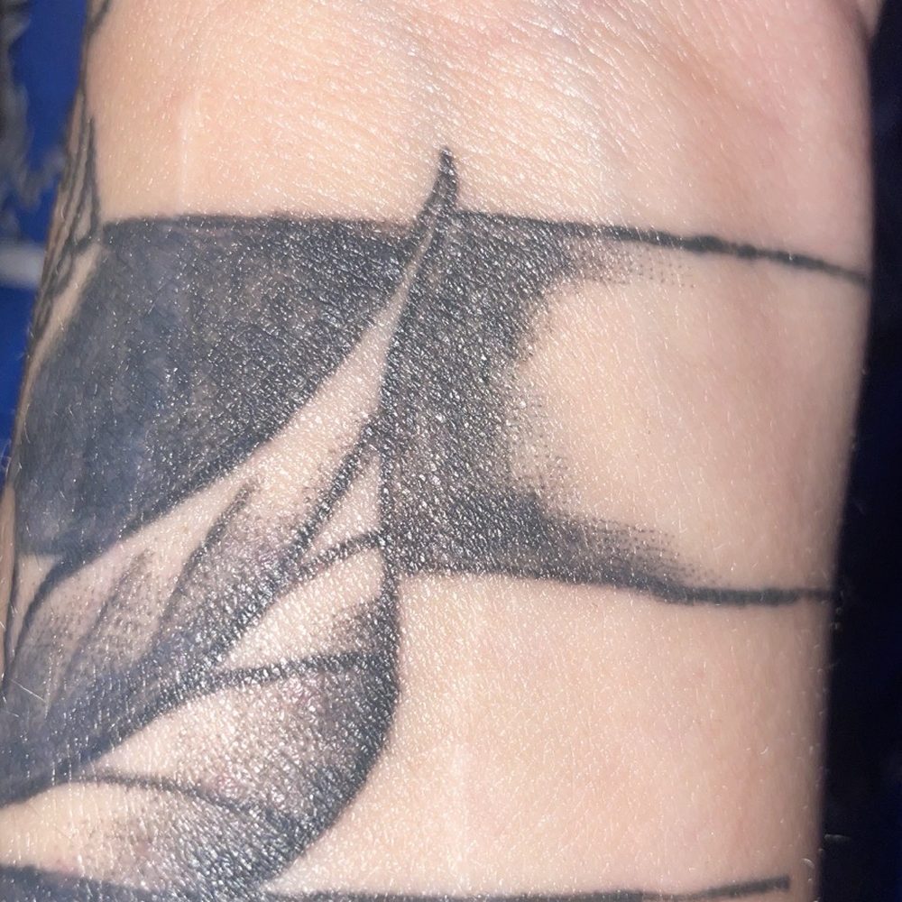 The Company - Wrist tattoo with visible shading issues and uneven line transitions - Tattoo Near Me - Reno, Nevada