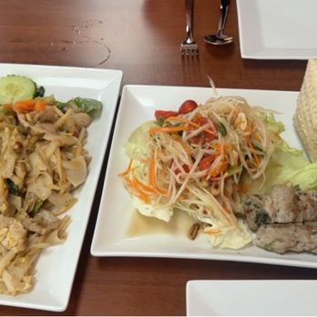 Pure Thai Kitchen - Drunken Noodles (Pad Ke Mao) and Moo Ping Som Tum appetizer with sticky rice - Thai Near Me - Cave Creek, Arizona Pure Thai Kitchen - Drunken Noodles (Pad Ke Mao) and Moo Ping Som Tum appetizer with sticky rice - Thai Near Me - Cave Creek, Arizona