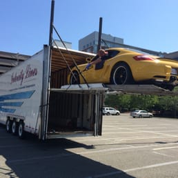 Intercity driver loading my Cayman, with care, into the fancy double-decker trailer.