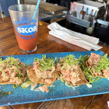 Siesta Key Oyster Bar - Tuna Poke Bites Sesame marinated Ahi Tuna, avocado, sriracha aioli, on crispy wontons, topped with sesame seed, cilantro and scallion - Seafood Near Me - Sarasota, Florida