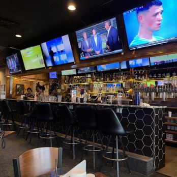 Report In Pub - a man sitting at a bar watching tvs - Pubs Near Me - Omaha, Nebraska Report In Pub - a man sitting at a bar watching tvs - Pubs Near Me - Omaha, Nebraska
