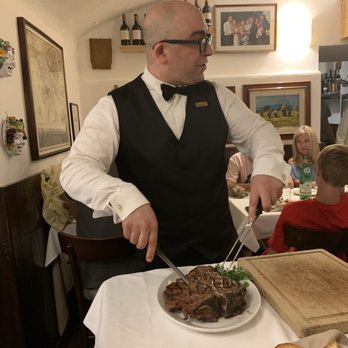 Buca Mario - Our awesome waiter cutting our steak - Tuscan Near Me - Florence, FI Buca Mario - Our awesome waiter cutting our steak - Tuscan Near Me - Florence, FI