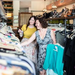 Valhalla Resale - Ashley helping a member pick out her outfits for the week. Photo by Christina Jones Photography