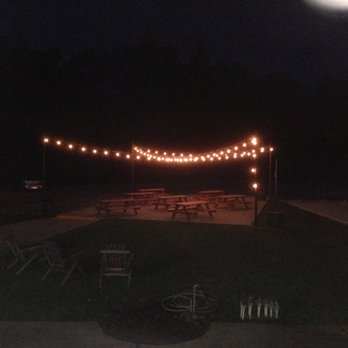BackRoad Vines - Outdoor picnis tables lit up in the dark at BackRoad Vines in Fairfield. - Wine Tasting Room Near Me - Fairfield, California